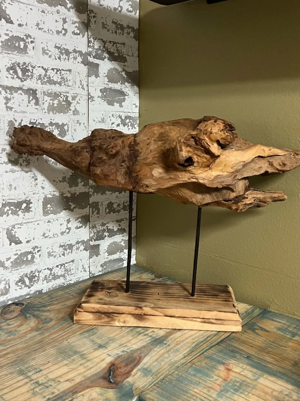 Natural weathered wood teak root rustic tabletop art piece supported by metal